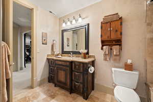 Bathroom featuring vanity, toilet, and tile patterned flooring