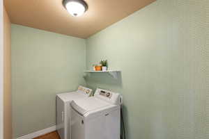 Washroom featuring washing machine and dryer