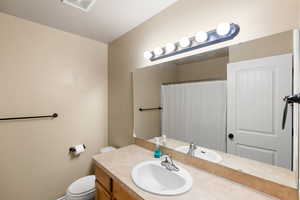 Bathroom featuring vanity and toilet