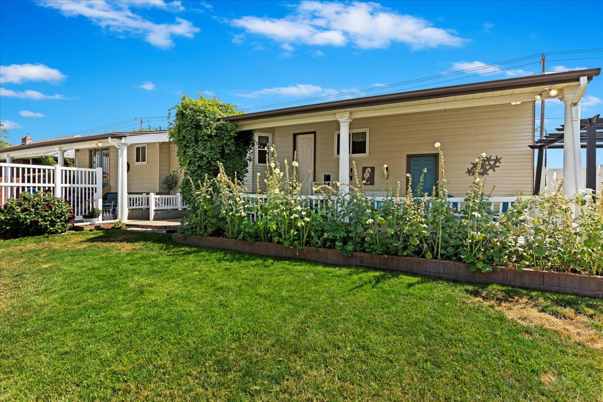 Rear view of property featuring a yard