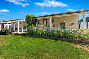 Rear view of property featuring a yard