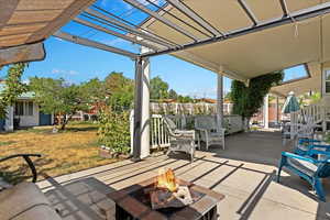 View of patio featuring a fire pit and a pergola