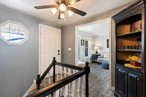 Corridor with a healthy amount of sunlight and hardwood / wood-style floors