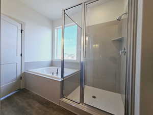 Bathroom featuring independent shower and bath and wood-type flooring