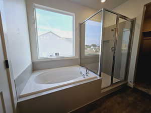 Bathroom featuring plus walk in shower and hardwood / wood-style floors