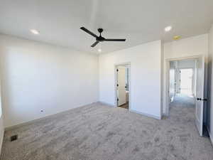 primary bedroom featuring carpet and ceiling fan