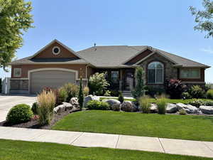 View of front of property featuring a garage and a front yard