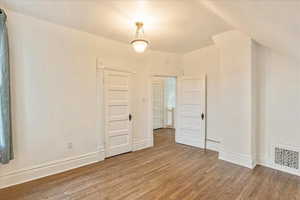 Second bedroom with lofted ceiling and wood floor.