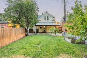 Back of property featuring a yard and a patio area