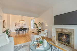 Living room with a fireplace, hardwood / wood-style floors, and ornamental molding