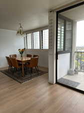 Dining space featuring light hardwood / wood-style flooring and a chandelier