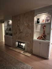 Unfurnished living room with light hardwood / wood-style flooring and a fireplace