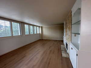 Unfurnished living room with a fireplace and hardwood / wood-style flooring