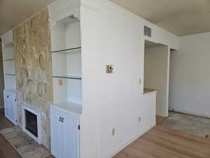 Interior space featuring crown molding and light hardwood / wood-style flooring