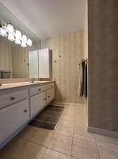 Bathroom with vanity, a textured ceiling, and tile patterned floors