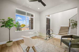 Home office featuring ceiling fan and wood-type flooring