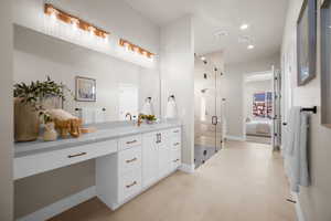 Bathroom featuring vanity, tile patterned floors, and a shower with shower door