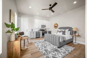 Bedroom with ceiling fan and light hardwood / wood-style flooring