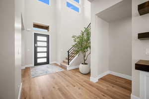 Foyer entrance featuring a high ceiling and hardwood / wood-style flooring