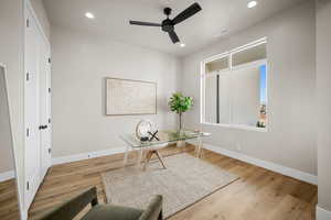 Office area featuring ceiling fan and light hardwood / wood-style flooring