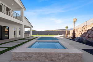 View of pool featuring a patio and an in ground hot tub