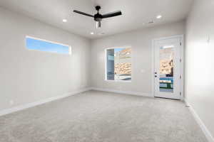 Carpeted empty room featuring ceiling fan