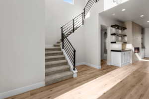 Stairs featuring hardwood / wood-style flooring