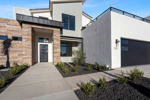 Doorway to property featuring a garage