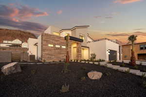 Contemporary home with a garage and central AC unit