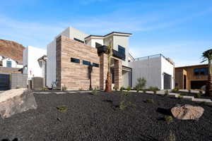 Exterior space with central AC and a garage