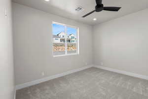 Unfurnished room featuring carpet and ceiling fan