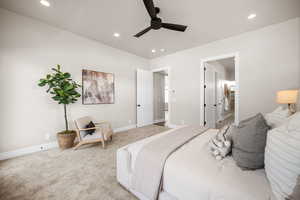 Carpeted bedroom with ceiling fan and ensuite bath