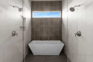 Bathroom featuring tile walls, tile patterned flooring, and plus walk in shower