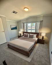 Bedroom featuring vaulted ceiling, a textured ceiling, and carpet flooring. Virtually staged