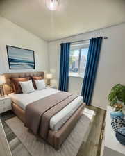 Bedroom with hardwood / wood-style flooring. Virtually staged