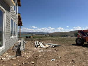 View of yard with a rural view and a mountain view