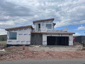 Property under construction with a garage