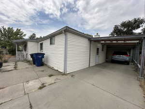 View of property exterior with a carport