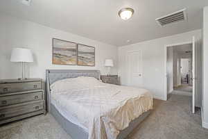 Bedroom featuring light carpet and a textured ceiling