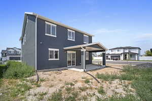 Rear view of house with a patio and a garage