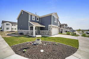 View of front of property featuring a garage and central AC unit