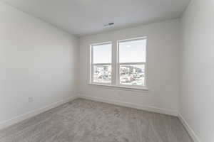 Empty room with light colored carpet