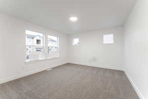 Unfurnished room with carpet