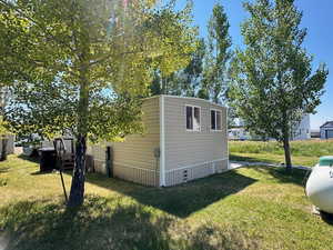 View of side of home featuring a yard