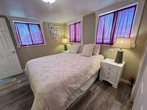 Bedroom featuring dark hardwood / wood-style flooring and ornamental molding