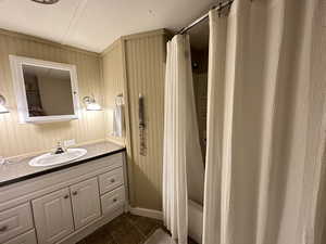 Bathroom featuring vanity, tile patterned flooring, and shower / bath combination with curtain