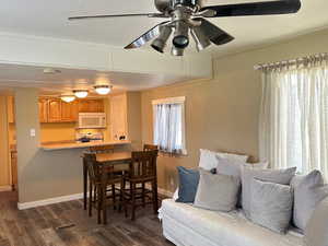 Interior space with dark wood-type flooring and ceiling fan