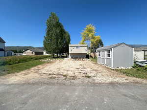 View of yard featuring a storage unit