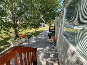 Deck featuring a lawn and a patio area