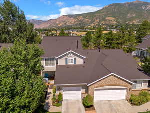 View of front of home with a garage and a mountain view